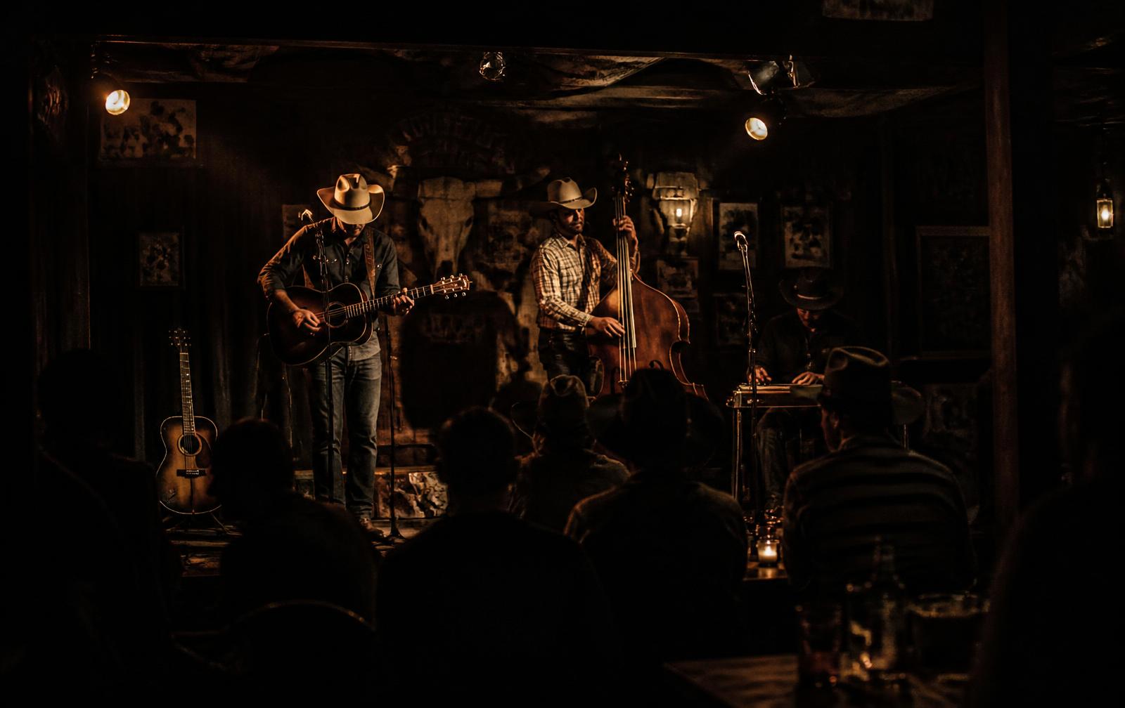 Band playing on a low stage in a rustic bar
